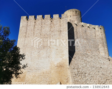 Close-up of medieval stone battlements and tower of Castellet Castle. Close-up of medieval stone battlements and tower of Castellet Castle. 138912643