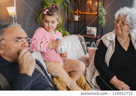 Family bond through fun karaoke session at home together Family bond through fun karaoke session at home together 138912752