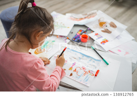 Creative child engaged in colorful art time at home Creative child engaged in colorful art time at home 138912765