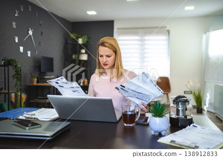 Blonde woman working with a lot of paperwork Blonde woman working with a lot of paperwork 138912833