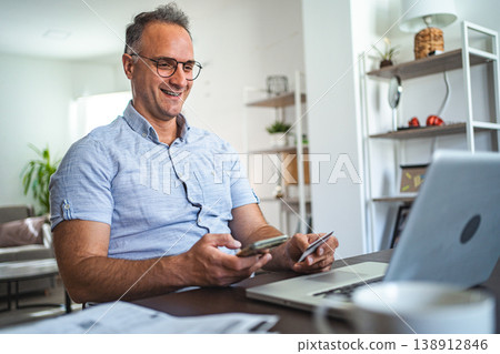 Middle aged Caucasian man online shopping at home Middle aged Caucasian man online shopping at home 138912846