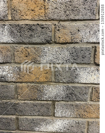 Different shades on a brick wall in a city building during daytime hours Different shades on a brick wall in a city building during daytime hours 138912888