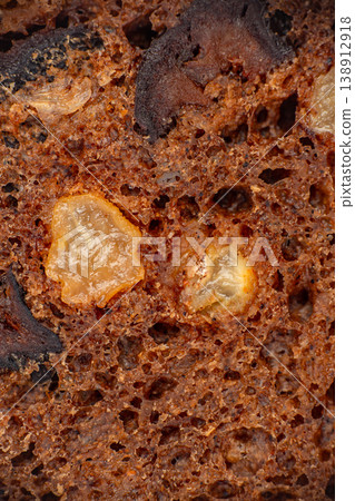 Fruit loaf cake texture closeup, baked crumb with raisins and candied fruit macro Fruit loaf cake texture closeup, baked crumb with raisins and candied fruit macro 138912918
