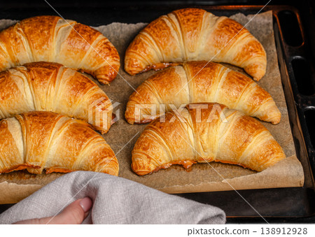 Fresh baked croissants on tray just out of oven Fresh baked croissants on tray just out of oven 138912928