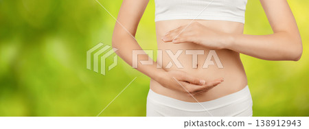 Woman holding stomach on green background, digestive health and gut care concept 138912943
