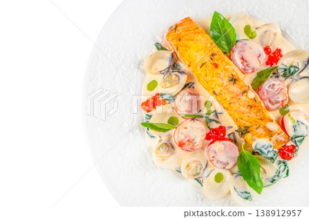 Salmon fillet with clams and creamy sauce on plate with copy space 138912957