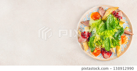 Top view of gourmet appetizer plate with fresh salad, sliced meat, cheese and berry sauce on light background with copy space Top view of gourmet appetizer plate with fresh salad, sliced meat, cheese and berry sauce on light background with copy space 138912990