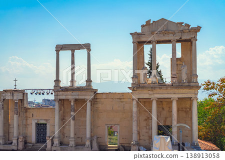 Ancient roman theater facade, columns statues, stone structure in Plovdiv under blue sky, historic architecture landmark. Cultural heritage, archaeological site, ancient history, past civilization 138913058