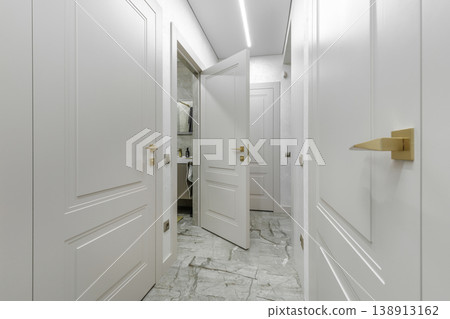 Bright Hallway Interior with Multiple White Classic Doors 138913162