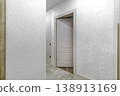 Slightly Ajar Classic White Door in Bright Hallway Interior 138913169