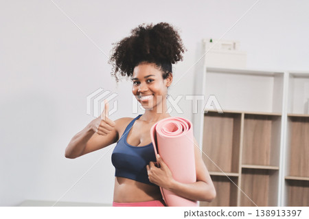 Women exercising in fitness studio yoga classes Women exercising in fitness studio yoga classes 138913397