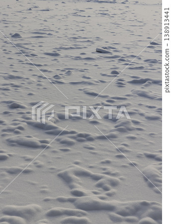small drifts of white soft snow after snowfall and frosts on the river, uneven snow structure in sunny weather small drifts of white soft snow after snowfall and frosts on the river, uneven snow structure in sunny weather 138913441