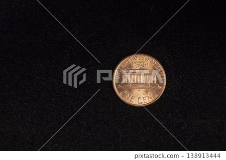 an American one-cent coin on black velvet, close up 138913444