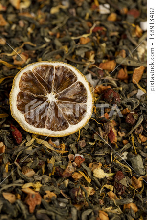 high-quality green tea with flavors and pieces of fruit and cut dried yellow lemons, bright large dry lemon slices and green tea with pieces of fruit 138913482