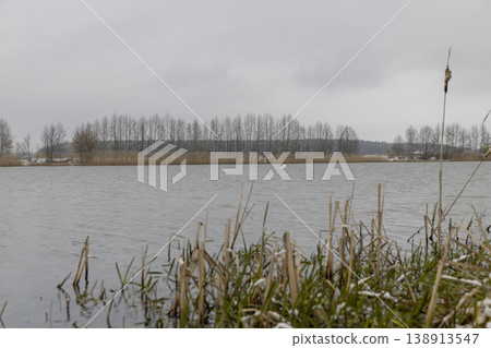 a river in early spring after snowfalls and winter frosts, new growth a river in early spring after snowfalls and winter frosts, new growth 138913547