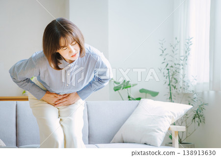 Middle-aged woman suffering from stomach pain 138913630
