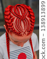 Creative red braided hairstyle with geometric patterns. Trendy urban look, fashion-forward concept. 138913899