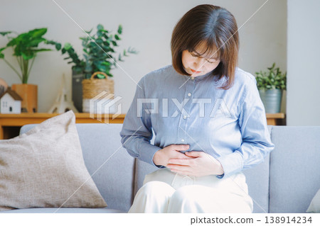 Middle-aged woman suffering from stomach pain 138914234