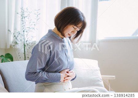 Middle-aged woman suffering from stomach pain 138914285