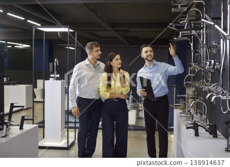 Salesman Helping Couple Choose Shower 138914637