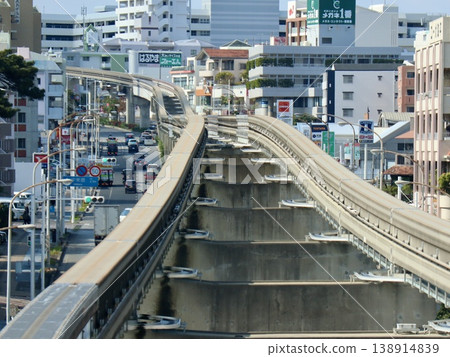 The elevated tracks of the Okinawa Yui Rail running through the city and the urban landscape of Naha (straight rails) | Tourism, transportation infrastructure, and reference materials 138914839