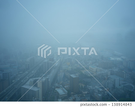 An aerial view of a city shrouded in mist. An aerial view of a city shrouded in mist. 138914843