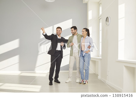 Real estate agent giving house tour for potential buyers, showing modern apartment Real estate agent giving house tour for potential buyers, showing modern apartment 138915416