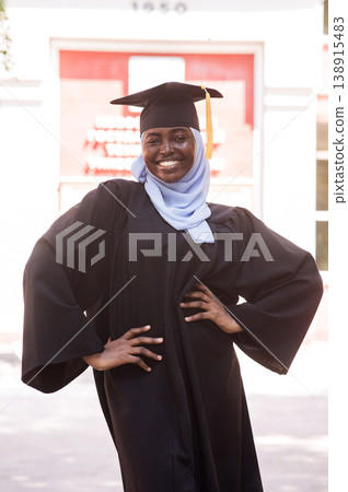 Portrait of happy african woman wearing hijab and graduation gown. Portrait of happy african woman wearing hijab and graduation gown. 138915483