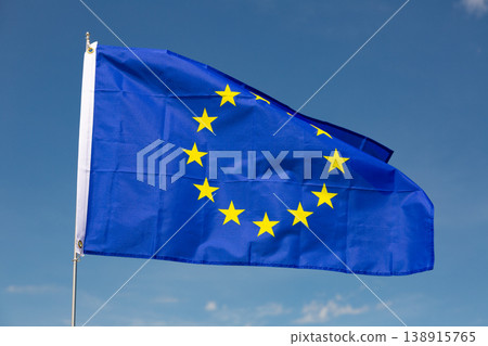 Flag of European Union flies on flagpole against blue sky 138915765