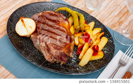 Beef sirloin steak with fries, pepper, onion, tomatoes Beef sirloin steak with fries, pepper, onion, tomatoes 138915801