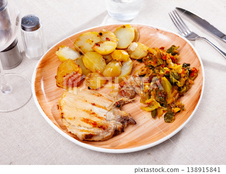 Grilled pork steak with fried potato and braised cabbage Grilled pork steak with fried potato and braised cabbage 138915841