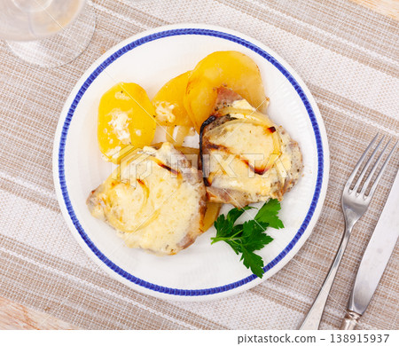 Grilled pork steak with gravy cheese and sliced potato on plate Grilled pork steak with gravy cheese and sliced potato on plate 138915937