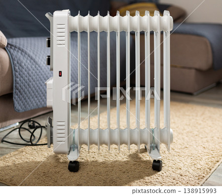 Oil filled radiator used in an room; standing in center of room Oil filled radiator used in an room; standing in center of room 138915993
