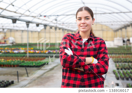 Female florist posing at greenhouse Female florist posing at greenhouse 138916017