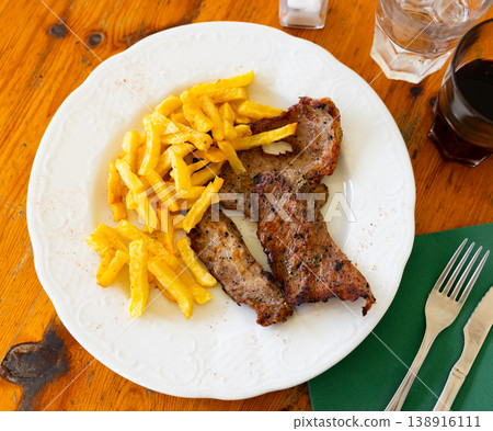 Pork secret served with potatoes on platter 138916111