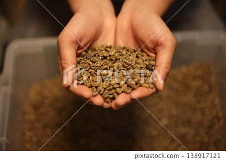 Man holding coffee beans Man holding coffee beans 138917121