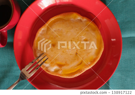 Homemade pancakes, overhead photo with red plate and blue-green tablecloth - Homemade pancake on Homemade pancakes, overhead photo with red plate and blue-green tablecloth - Homemade pancake on 138917122