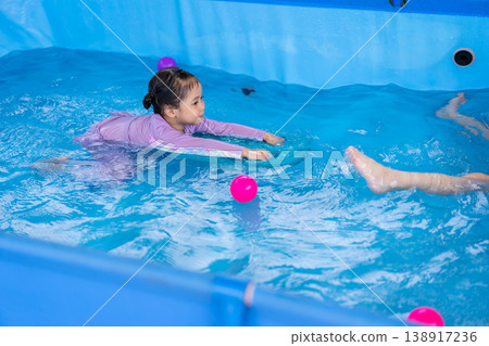 preschool child girl playing in swimming pool at home preschool child girl playing in swimming pool at home 138917236