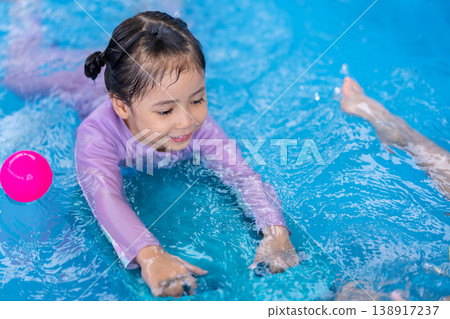 preschool child girl playing in swimming pool in backyard 138917237