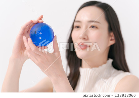 A woman with a glass globe A woman with a glass globe 138918066