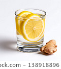 Fresh Lemon and Ginger Slices in a Clear Glass Filled with Water on a Clean Surface 138918896