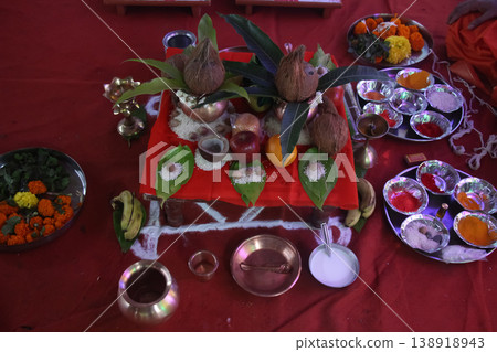 The setup includes a variety of puja samagri (ritual items) essential for the ceremony The setup includes a variety of puja samagri (ritual items) essential for the ceremony 138918943