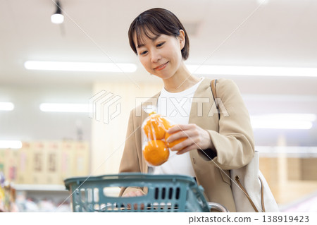 A woman shopping at a supermarket A woman shopping at a supermarket 138919423