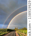 A Stunning and Beautiful Double Rainbow Over a Picturesque Scenic Road Surrounded by Nature 138919929