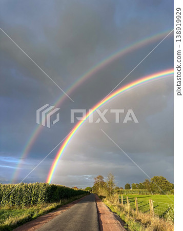 A Stunning and Beautiful Double Rainbow Over a Picturesque Scenic Road Surrounded by Nature A Stunning and Beautiful Double Rainbow Over a Picturesque Scenic Road Surrounded by Nature 138919929