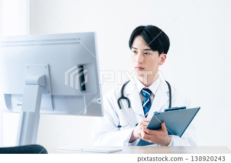 A young doctor at a computer A young doctor at a computer 138920243