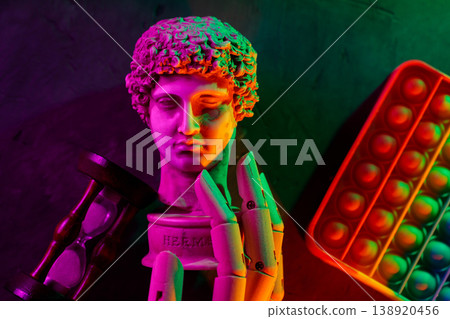 Neon lit classic bust sculpture with hourglass and colorful pop it toy Neon lit classic bust sculpture with hourglass and colorful pop it toy 138920456