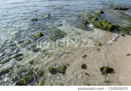 Calm waves and a small, crystal-clear sandy beach 138920635