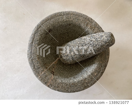Top View Of Traditional Granite Stone Mortar And Pestle On White Background Top View Of Traditional Granite Stone Mortar And Pestle On White Background 138921077