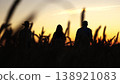 three farmers wheat field raised their hands up, agriculture, Farmers celebrating bountiful wheat harvest, Silhouetted figures golden wheat field sunset, Community spirit among farmers rural landscape 138921083